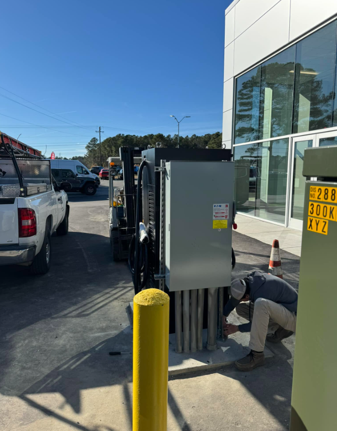 Electrician installing a commercial exterior disconnect and feeders